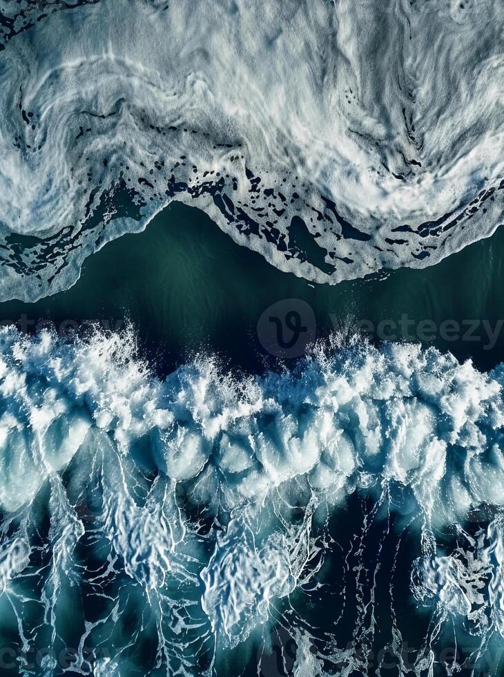Dramatic aerial view of powerful ocean waves with foam patterns photo