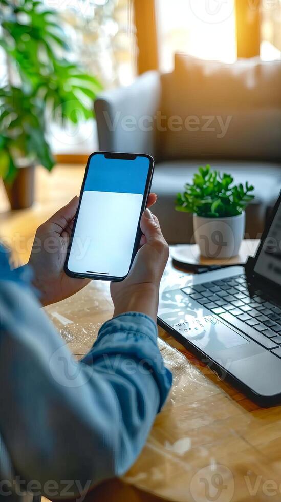 Businesswoman holding a smartphone in modern office environment photo