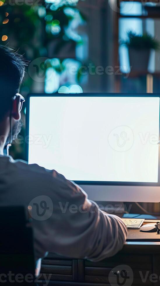 Nighttime Workspace with Man Using Desktop Computer photo