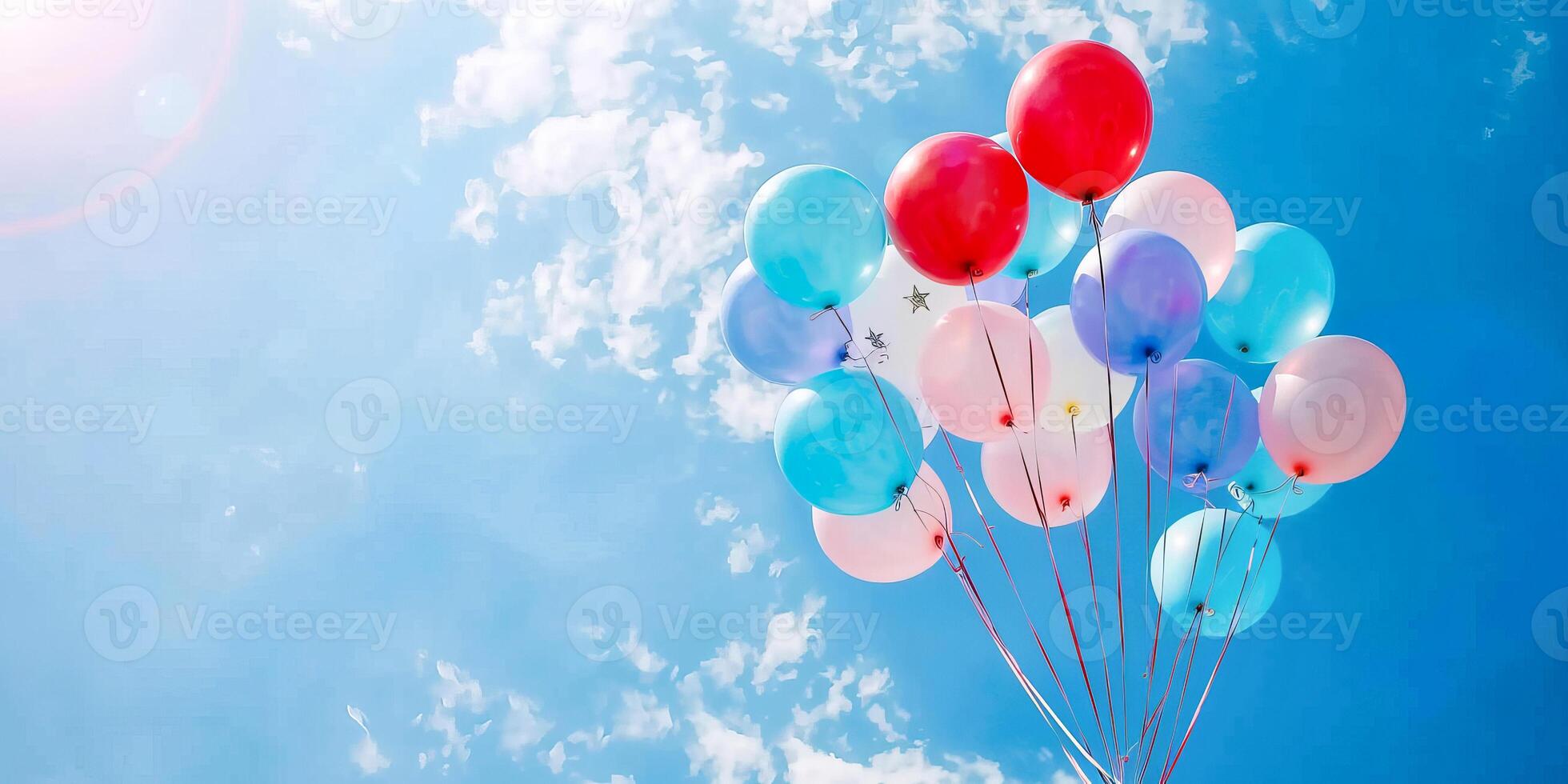 Colorful balloons soaring in blue sky with soft clouds photo