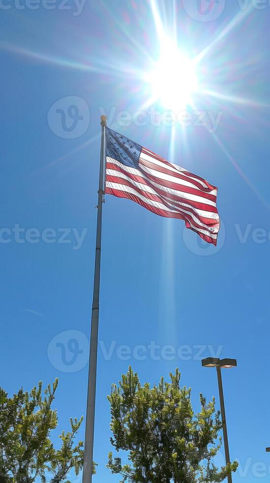 American Flag with Sunburst Effect in Clear Blue Sky photo