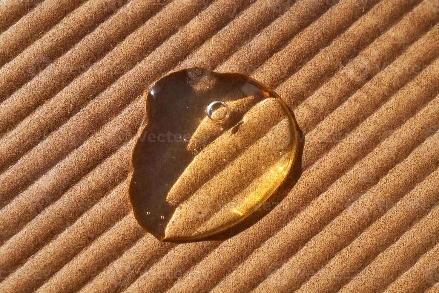 A drop of cosmetic oil on a corrugated surface. photo
