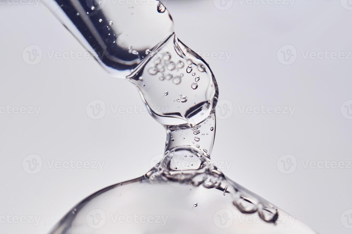 Pipette with cosmetic gel or serum close-up. photo
