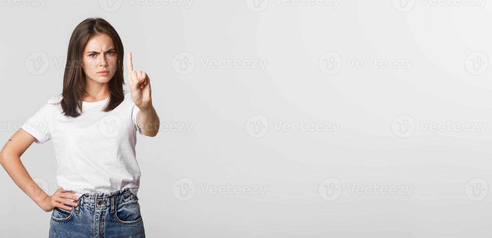 Angry disappointed woman shaking finger in disapproval, scolding person making wrong decision photo