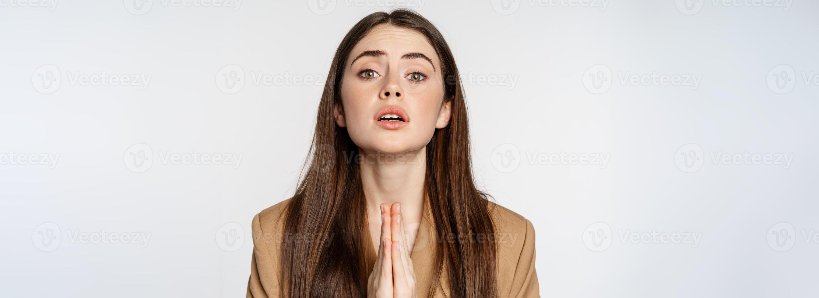 Close up portrait of corporate woman begging, pleading and saying please with desperate face expression, white background photo