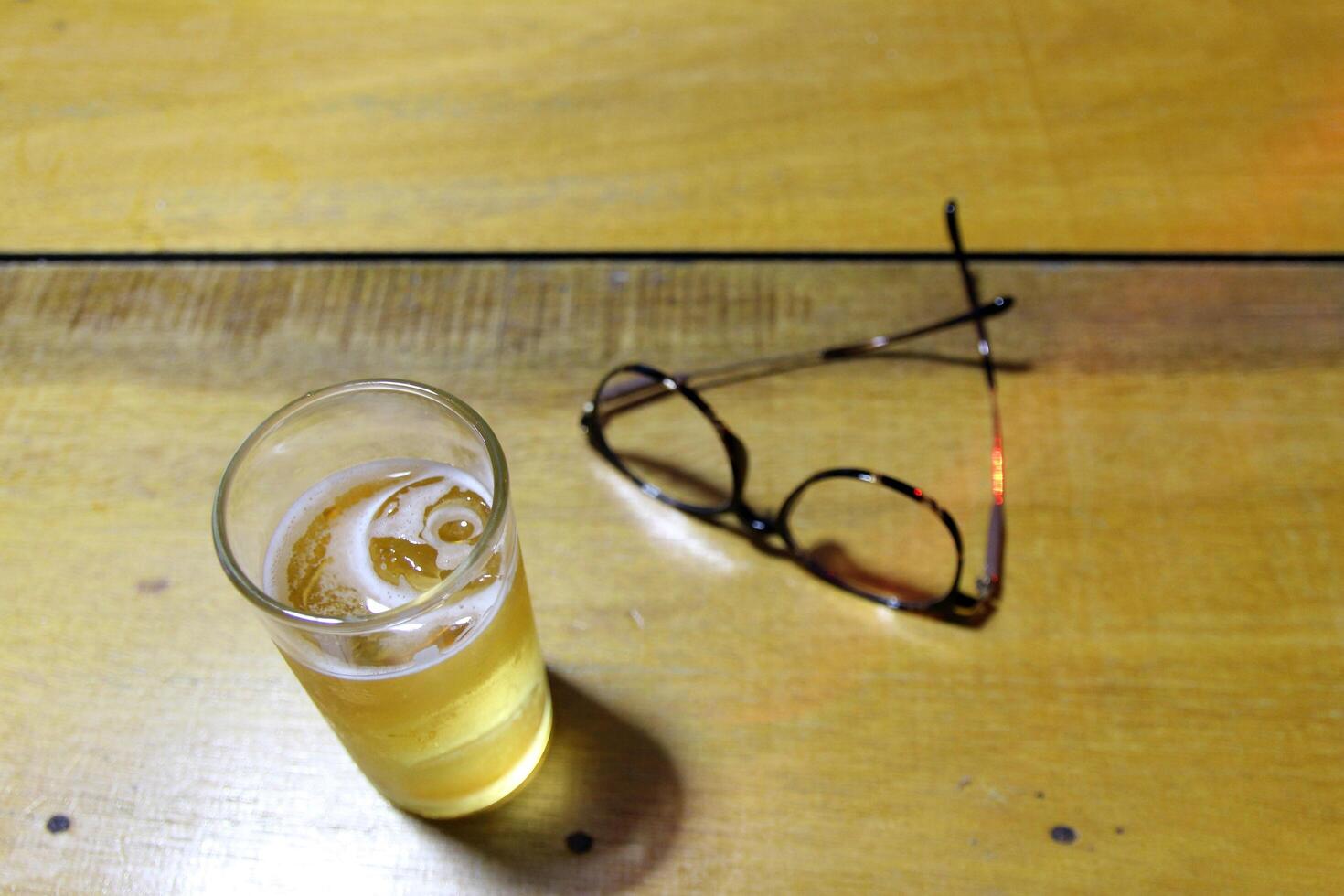 Take off your glasses and put them next to your glass after completing your daily tasks. Drinking is a way to relax and relieve stress. photo