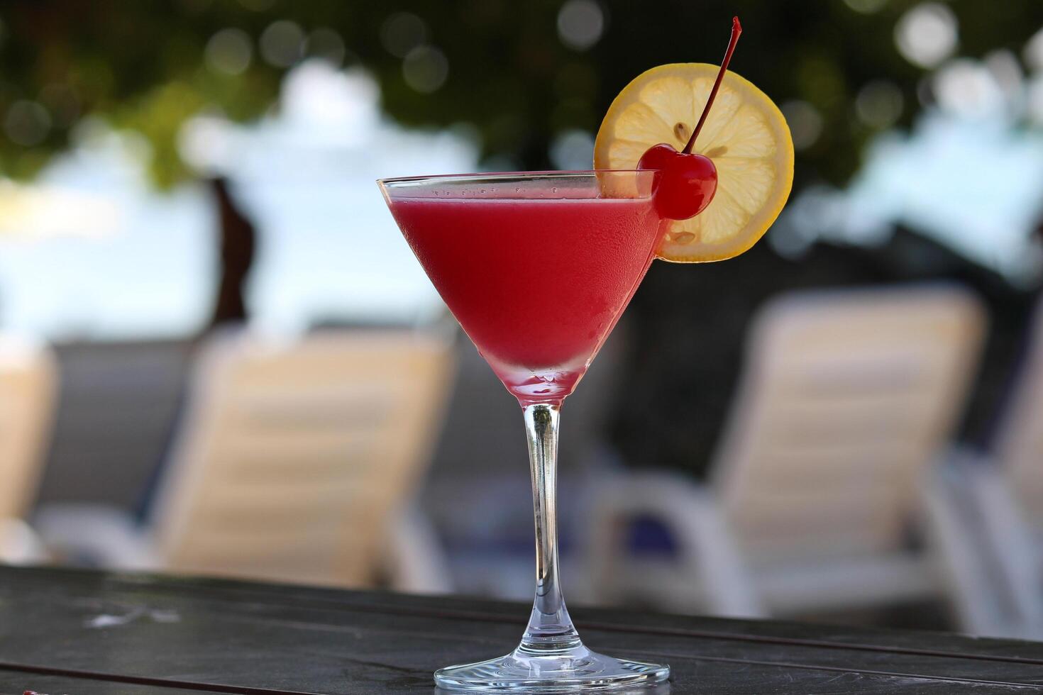 Smoothie juice has pieces of oranges and ornamental cherries. photo