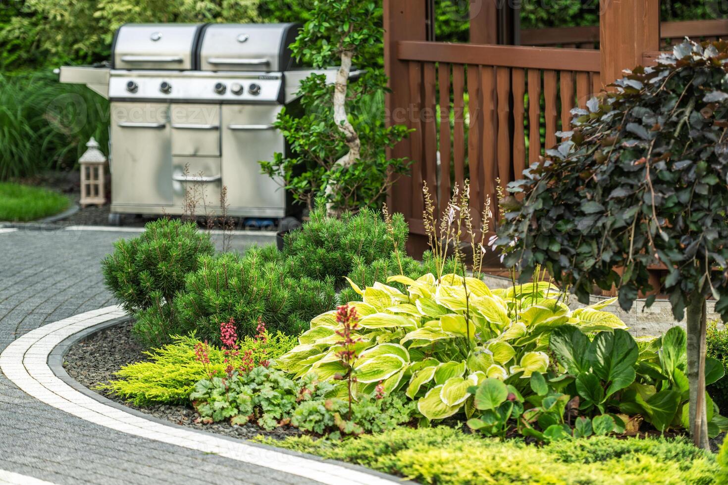 Lush Garden Landscape Featuring Grill Setup in a Backyard photo