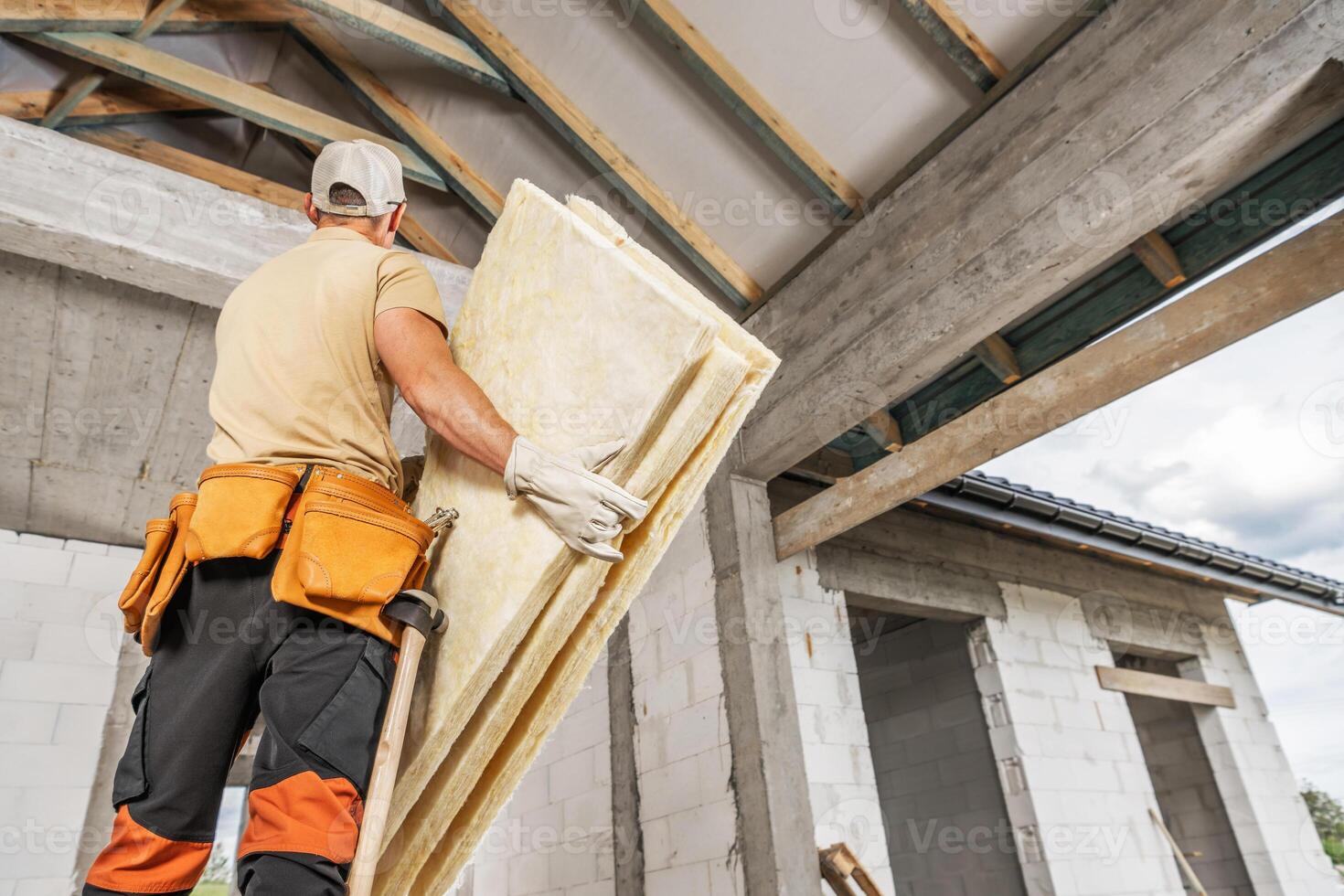 Construction Worker Installing Insulation in Residential Building Under Renovation photo
