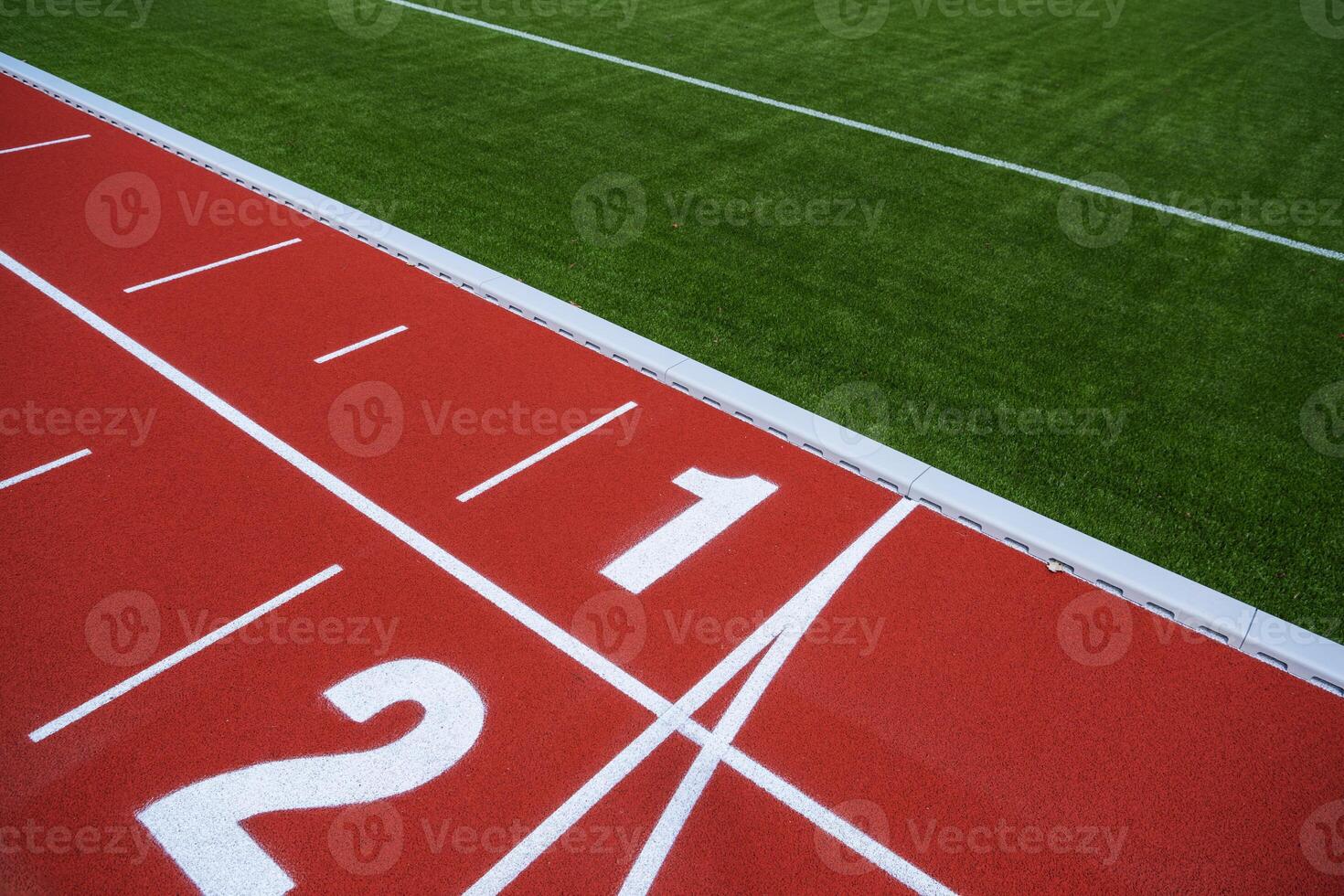 Close-Up of Athletic Track Starting Line With Markings and Artificial Turf photo