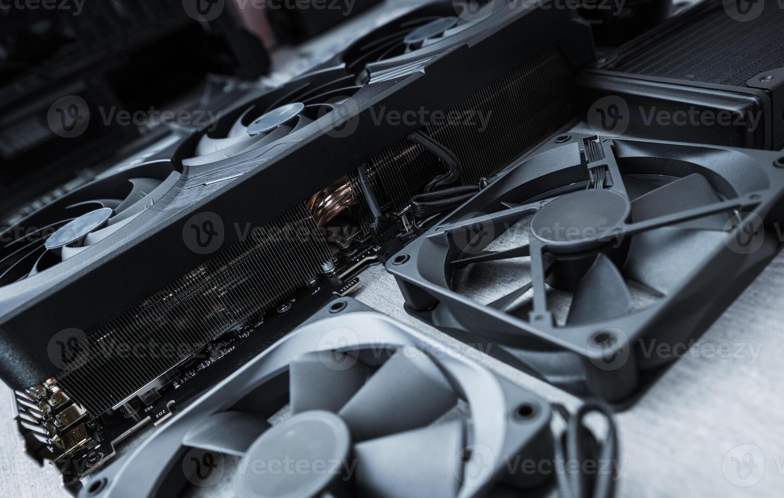 Computer Hardware Components Including Graphic Cards and Cooling Fans on a Workspace photo