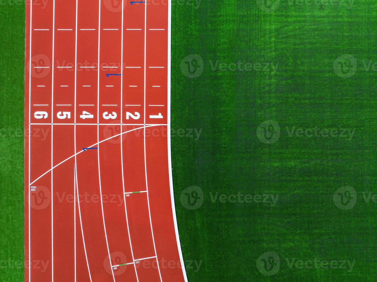Aerial View of a Red Running Track Next to a Green Grass Field During Daylight photo