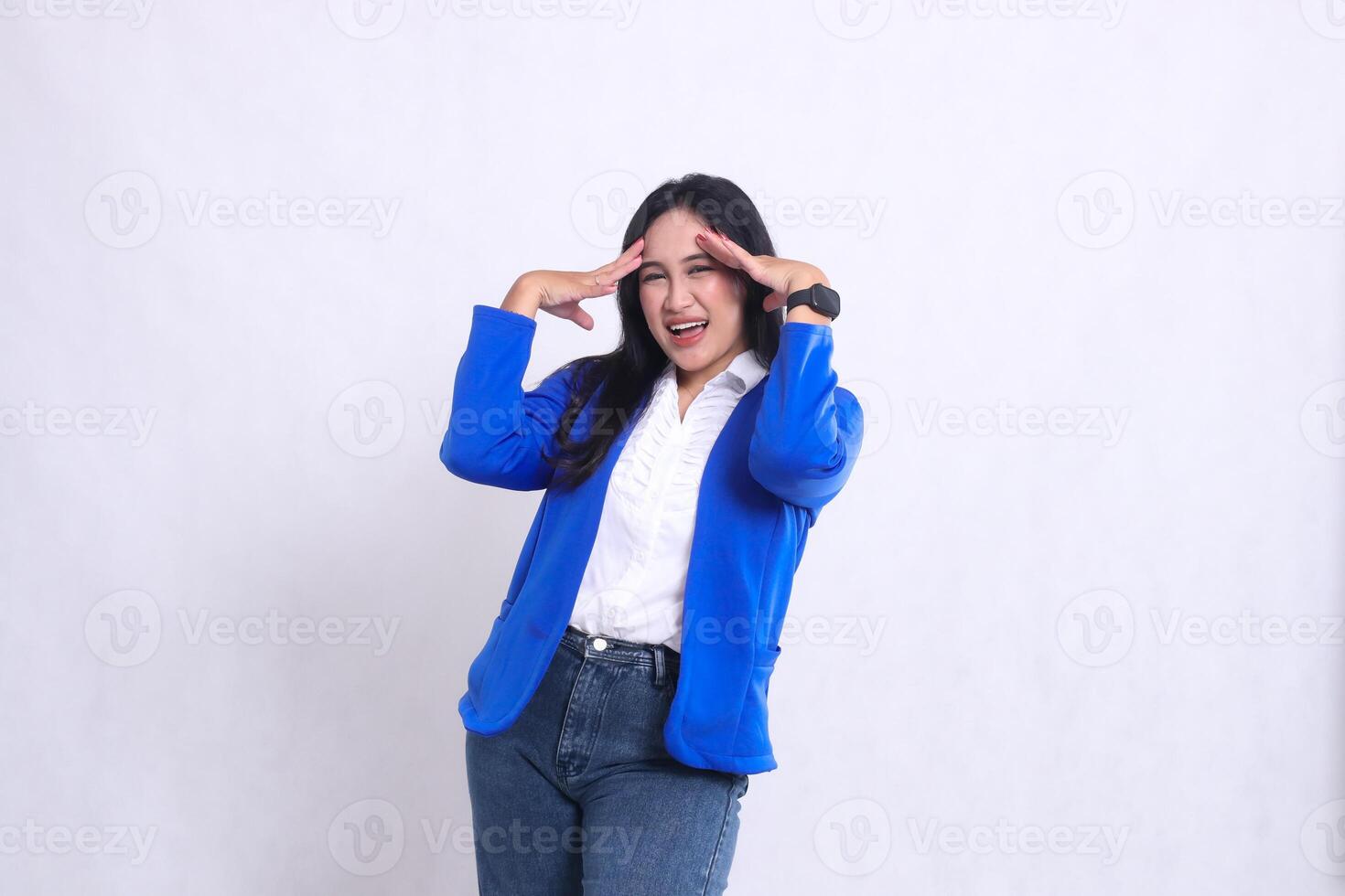 gesture of beautiful young office woman wearing a blue formal suit standing dizzy from the heat with both hands in front of her temples. for company, health, business, finance content, photo