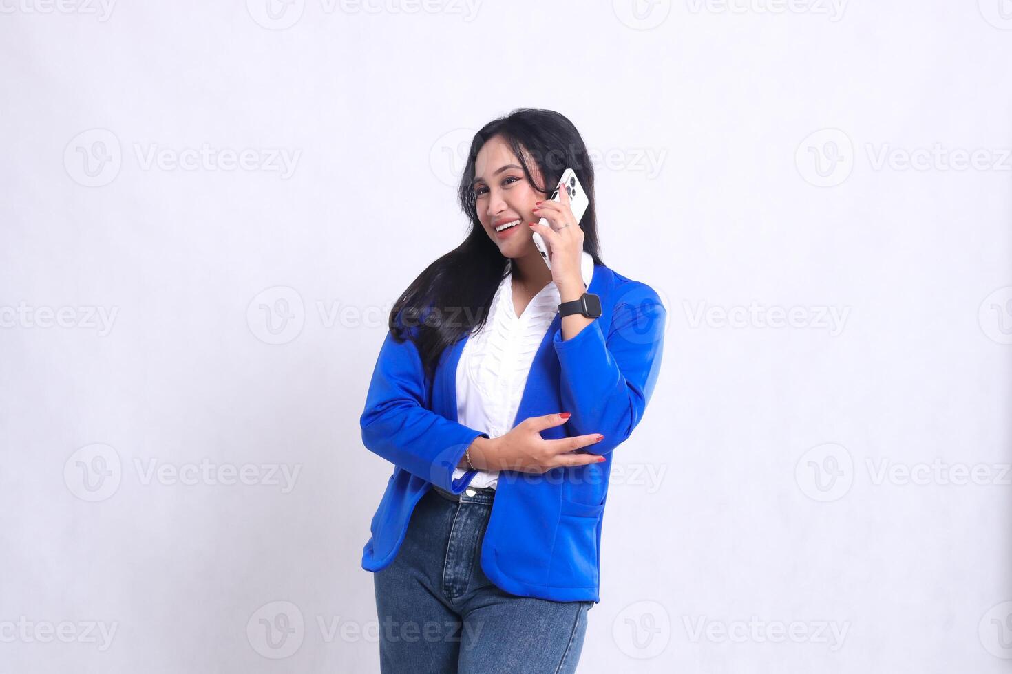 beautiful adult office woman wearing blue formal suit standing smiling cheerful candid while using smartphone cellphone isolated white background. for technology, lifestyle, communication content photo