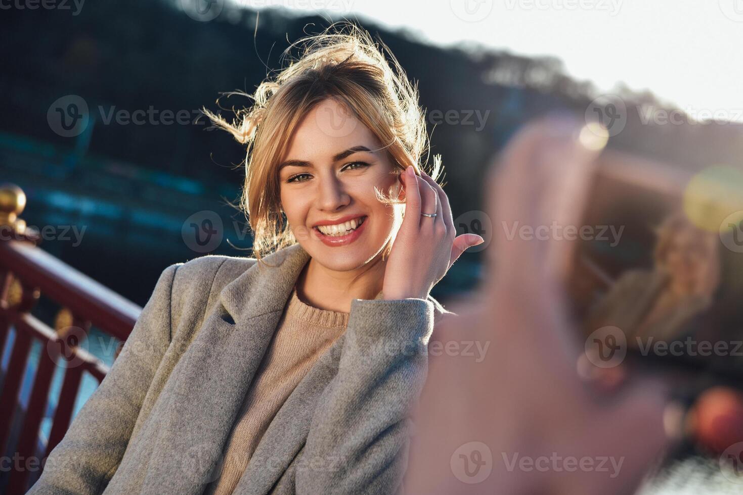Cheerful girl look at the camera in beautiful sunny day. Enjoying a sunny mood photo
