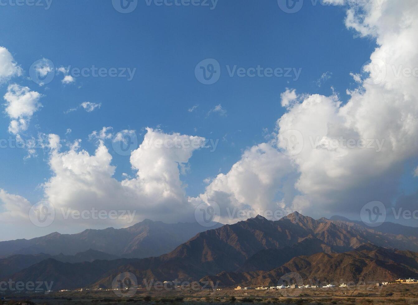 a view of mountains and clouds in the sky photo