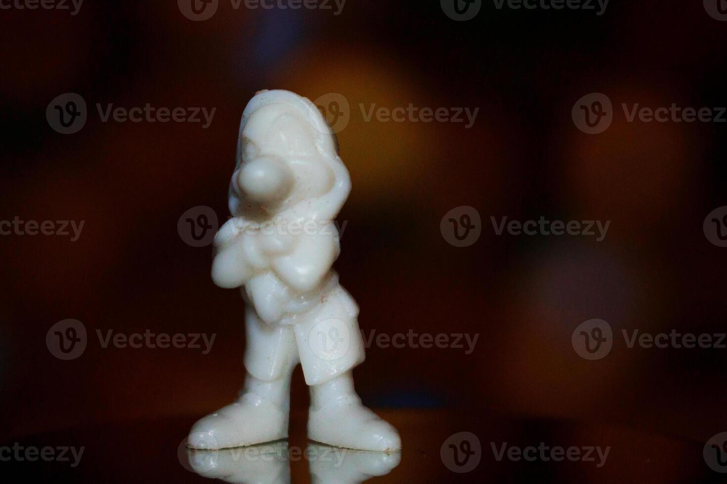 A white statue of a man standing with his arms crossed photo