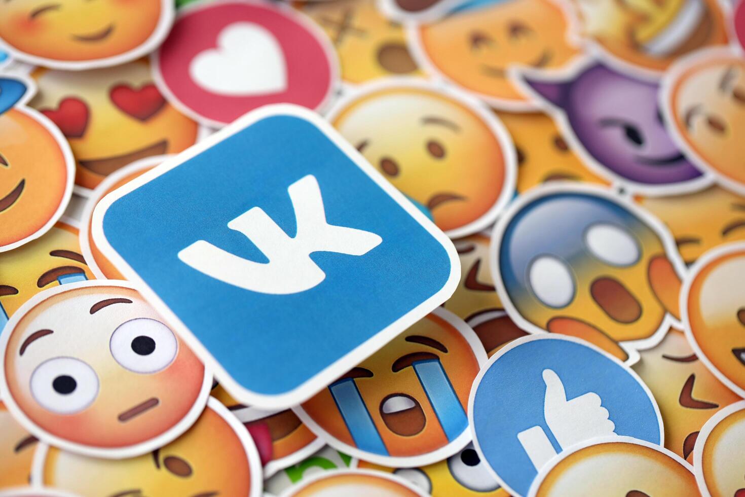 KYIV, UKRAINE - APRIL 20, 2024 VK logo and large set of stickers with Emoji yellow faces. Emoji is a pictogram or smiley embedded in text and used in electronic messages photo