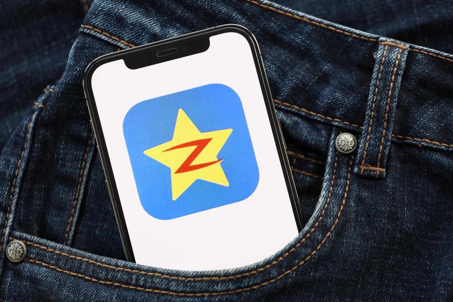 KYIV, UKRAINE - APRIL 1, 2024 Qzone icon on smartphone display screen in jeans pocket photo