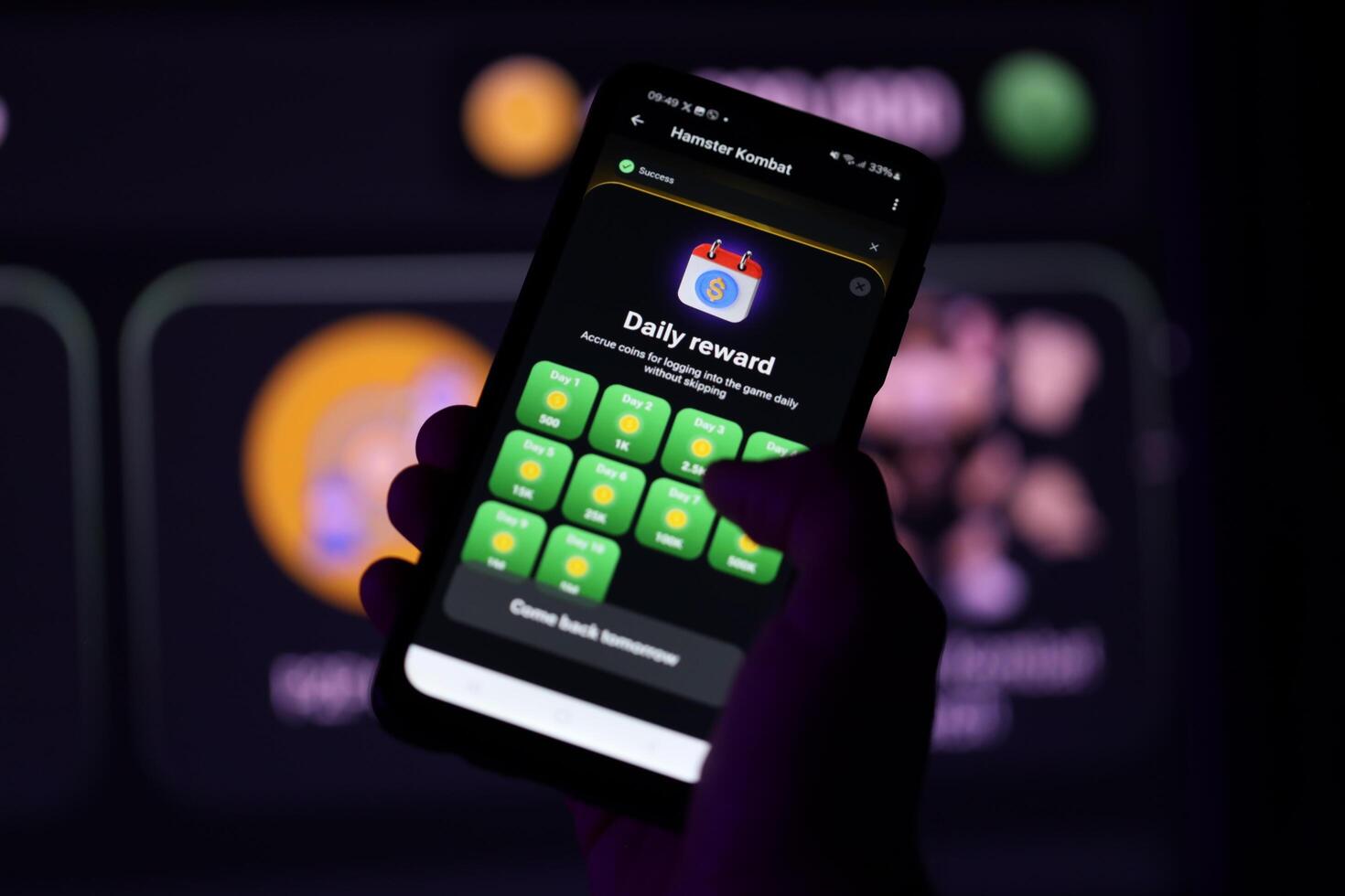 KYIV, UKRAINE - APRIL 20, 2024 Hamster Kombat telegram bot on smartphone screen. Hamster Kombat is a viral Telegram-based crypto game for earn HMSTR tokens by managing virtual crypto exchange photo