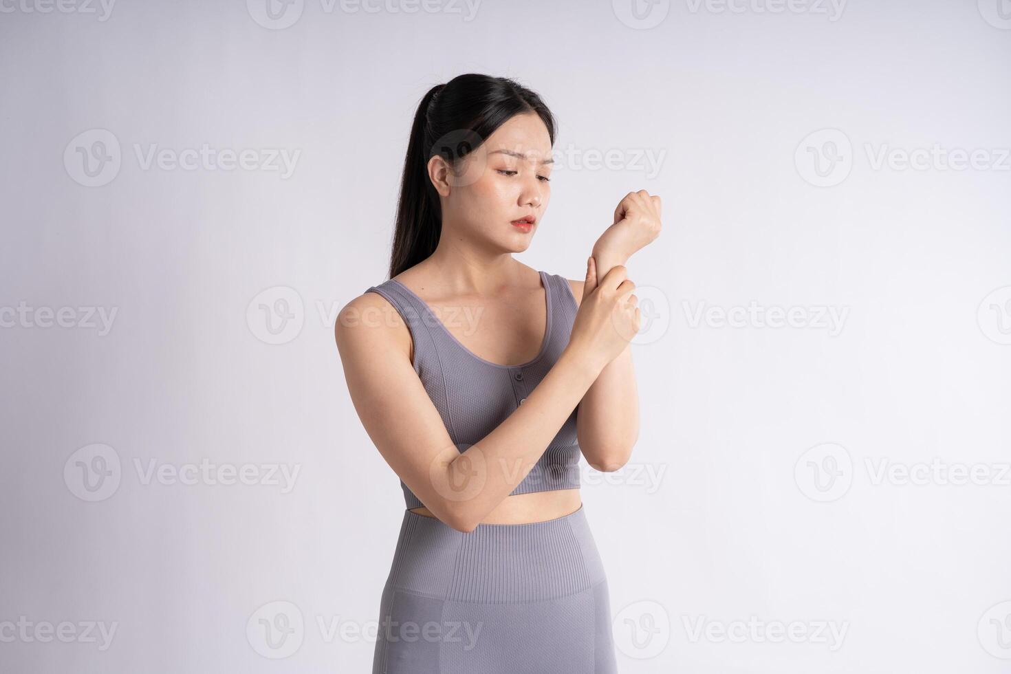 Portrait of Asian woman wearing sportswear, posing on white background photo