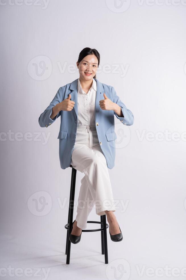 Portrait of young businesswoman posing on white background photo