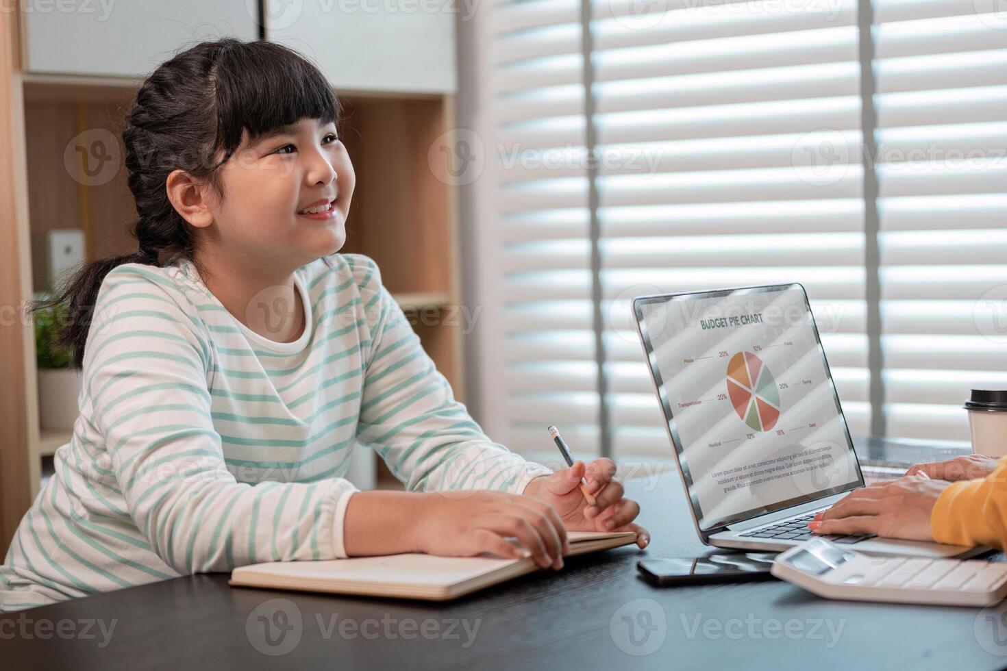 Mother and Child Working from Home Together in a Modern Home Office Setting with Laptop and Notebooks photo