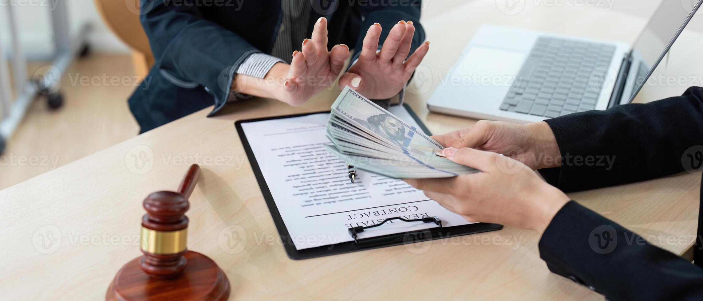 Lawyer Accepting Bribe Money for Corruption in Office Setting with Contract and Gavel on Desk photo