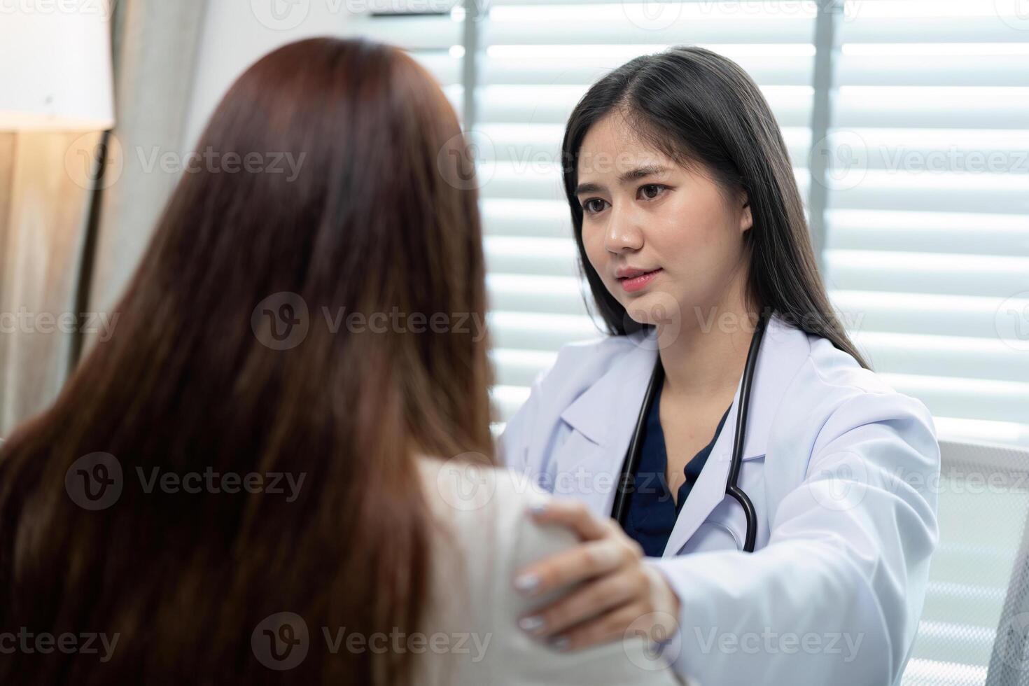 Compassionate Doctor Consulting with Patient in Modern Medical Office for Health Checkup and Diagnosis photo