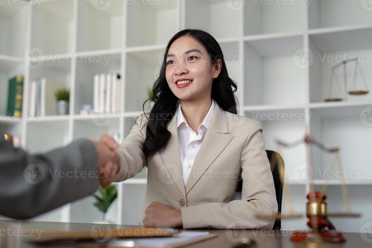 Confident Female Lawyer Shaking Hands with Client in Modern Office Setting, Symbolizing Professional Agreement and Trust photo