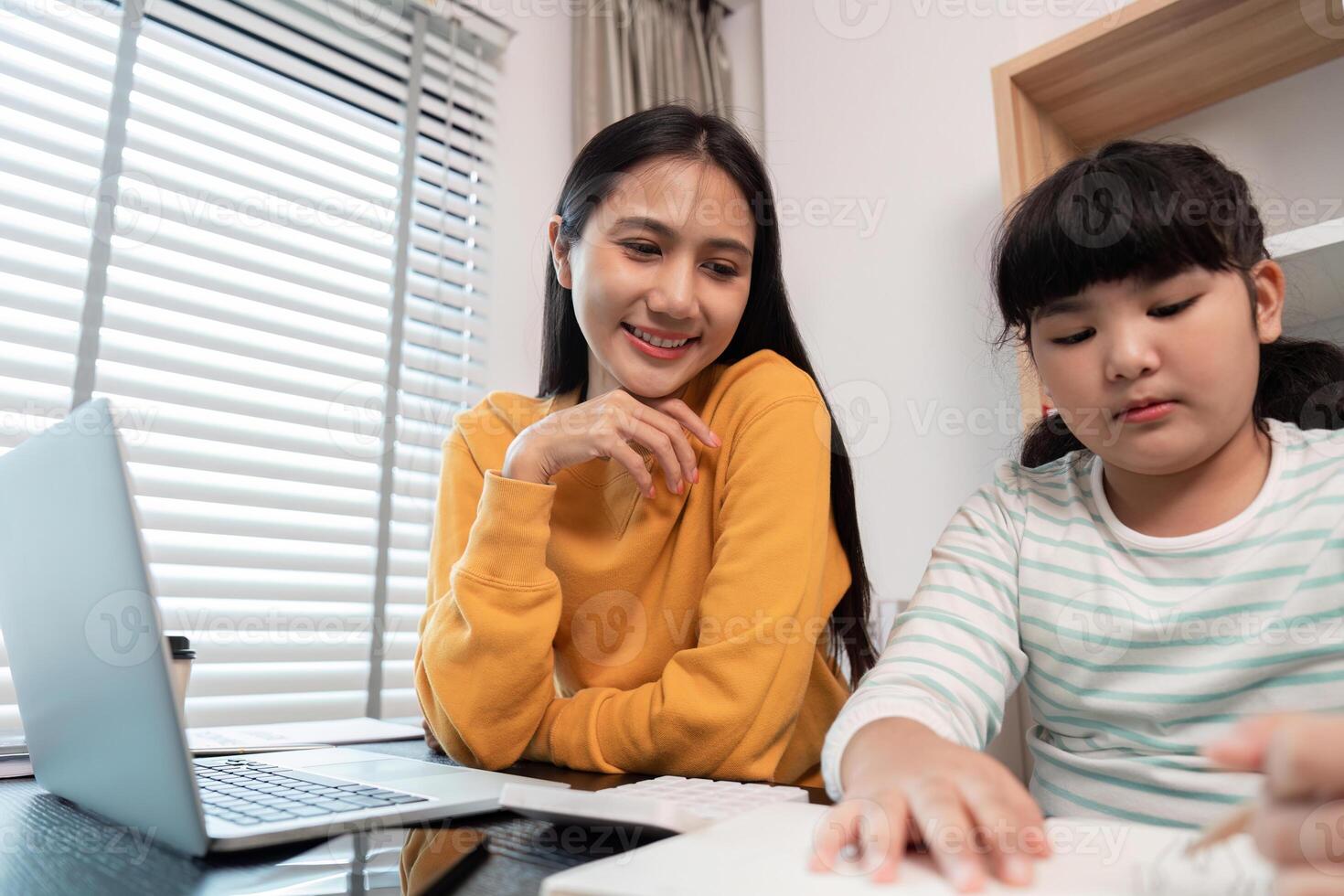 Mother and Child Working from Home Together on a Laptop and Homework in a Modern Home Office Setting photo