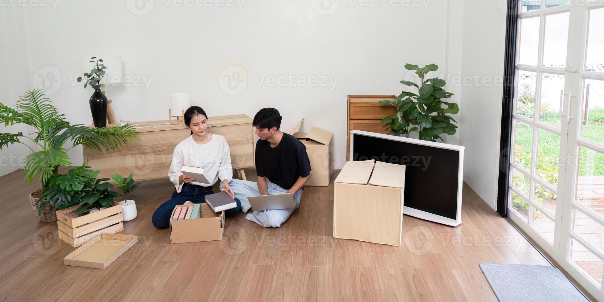 Young Couple Unpacking Boxes in New Home - Moving Day, Fresh Start, and New Beginnings photo
