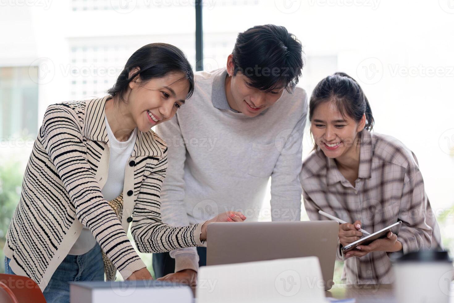 Group of Student Collaboration on a Project with a Laptop in a Modern Classroom Setting photo