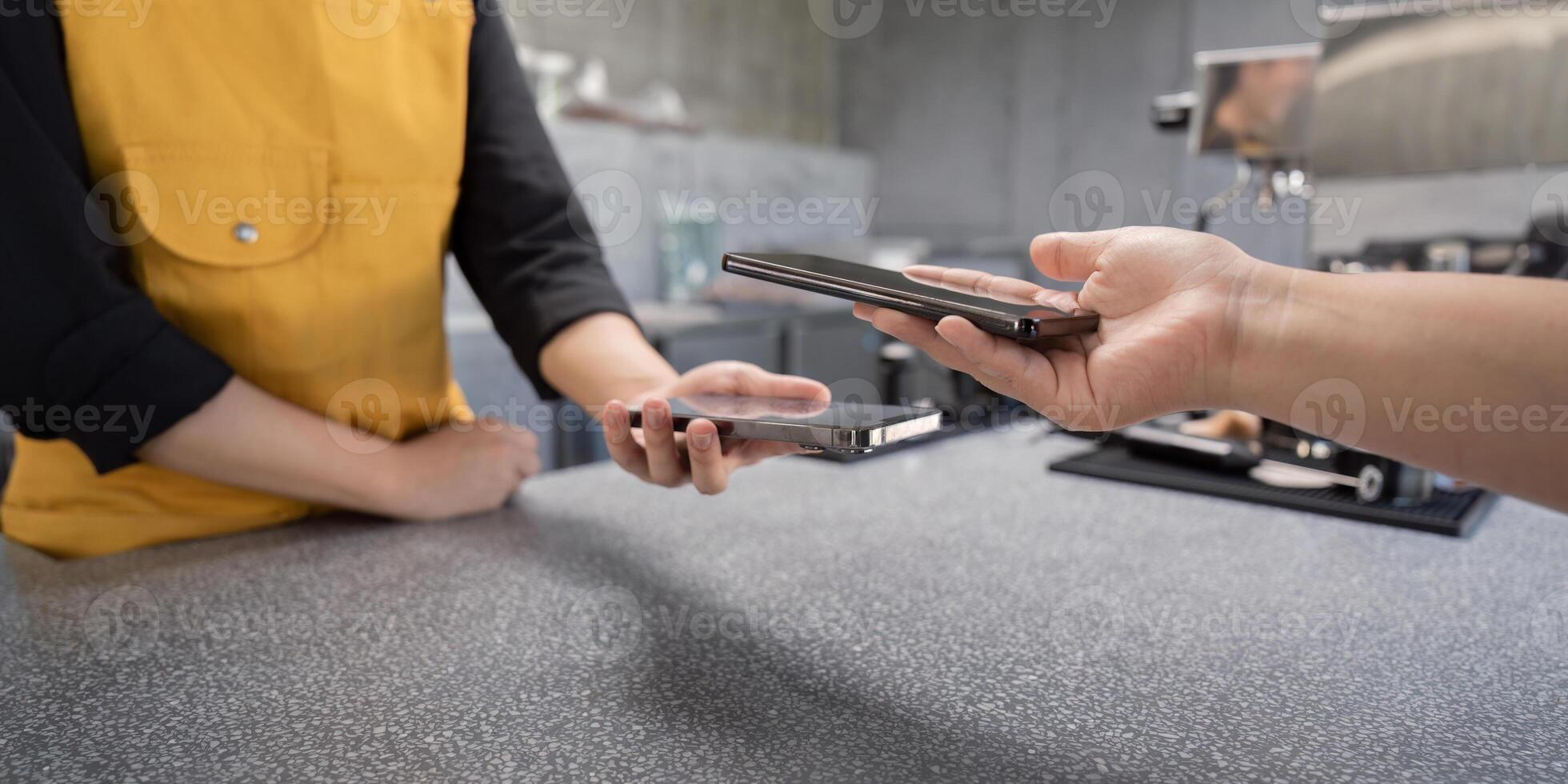 Contactless Payment Transaction in Modern Cafe with Smartphone Technology photo