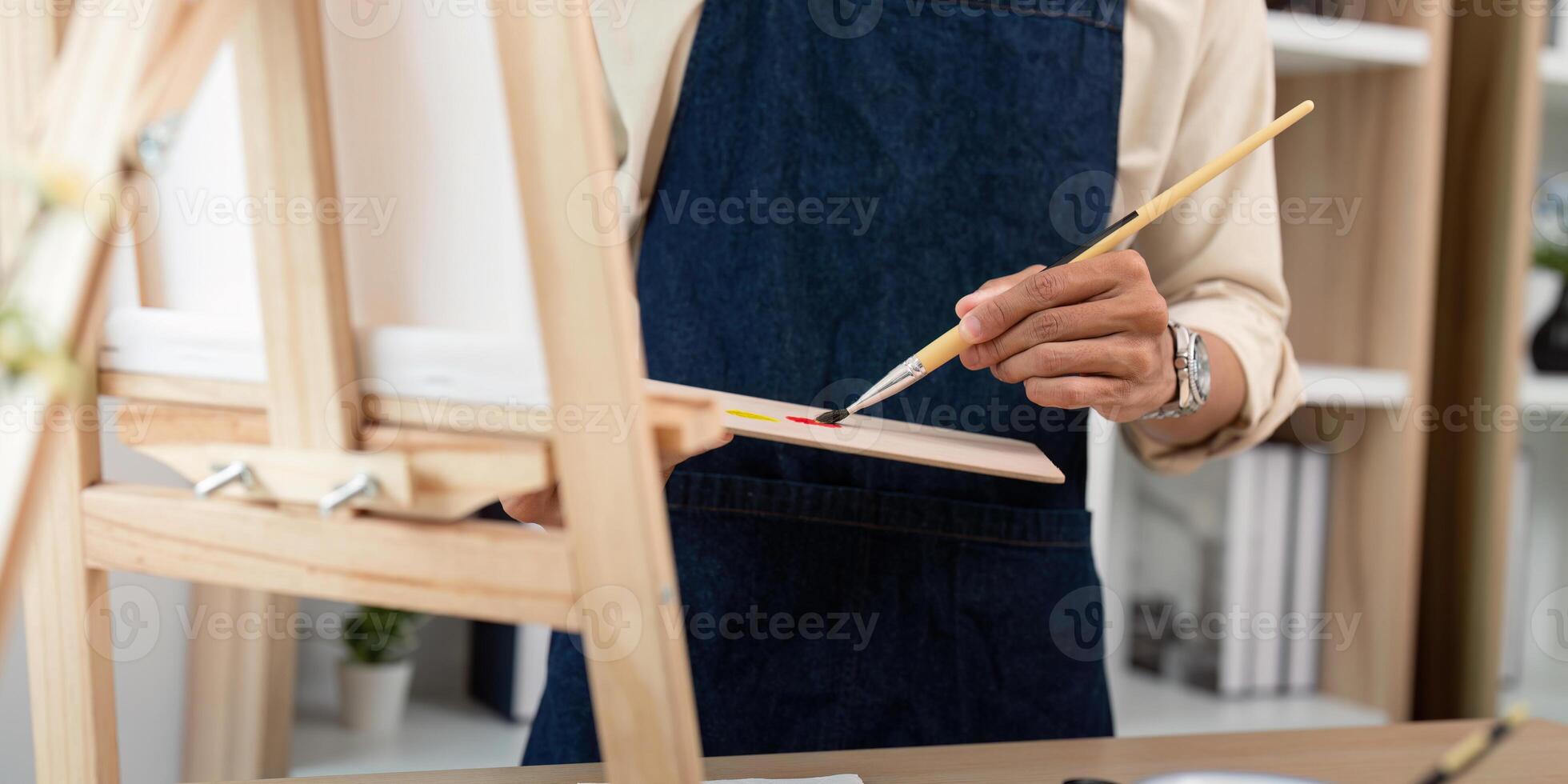 Artist Painting in Studio with Brush and Palette, Close Up of Hands and Canvas, Creative Process in Art Workshop photo