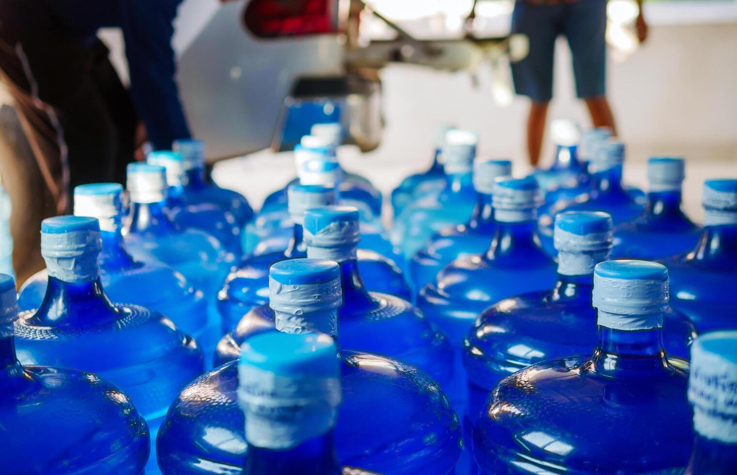 Drinking water clear and clean in blue gallon arranged in a row Prepare to lift into the back of a transport truck purified drinking water inside the production line to prepare for sale Water drink photo