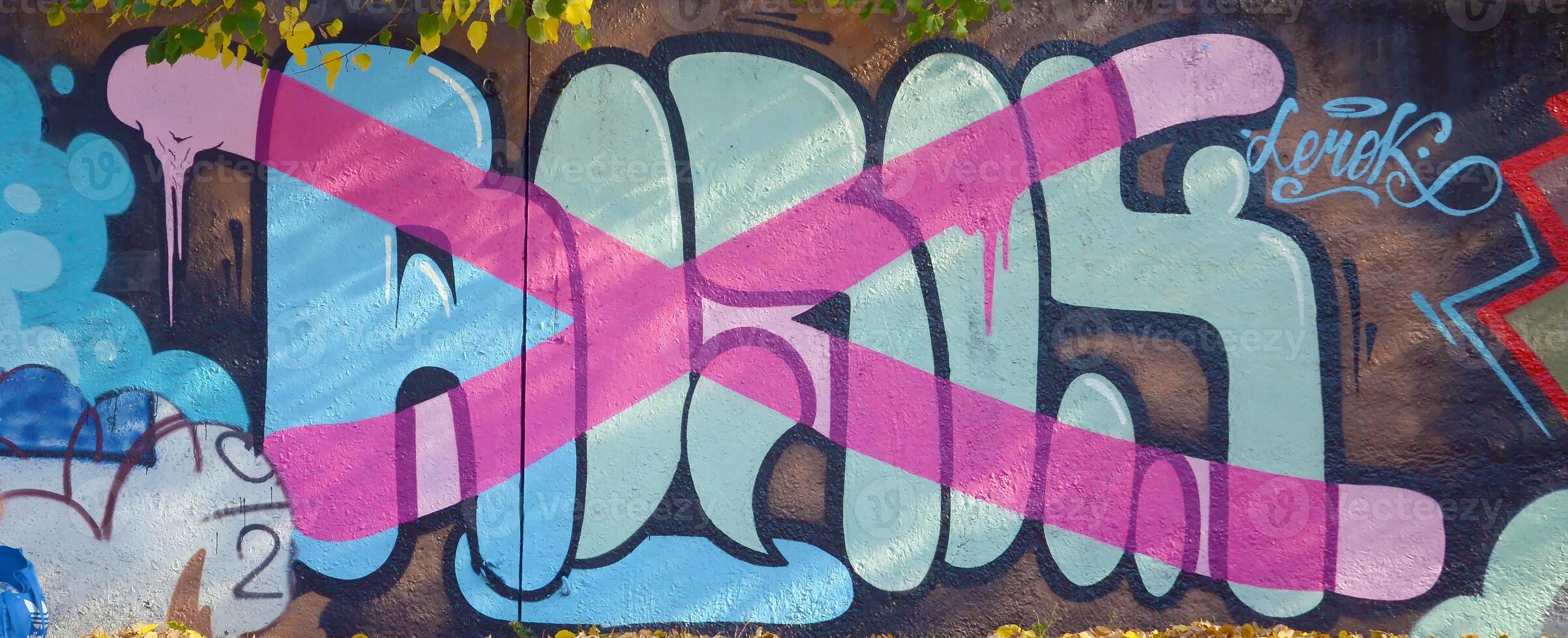 Colorful background of graffiti painting artwork with bright aerosol outlines on wall. Old school street art piece made with aerosol spray paint cans. Contemporary youth culture photo