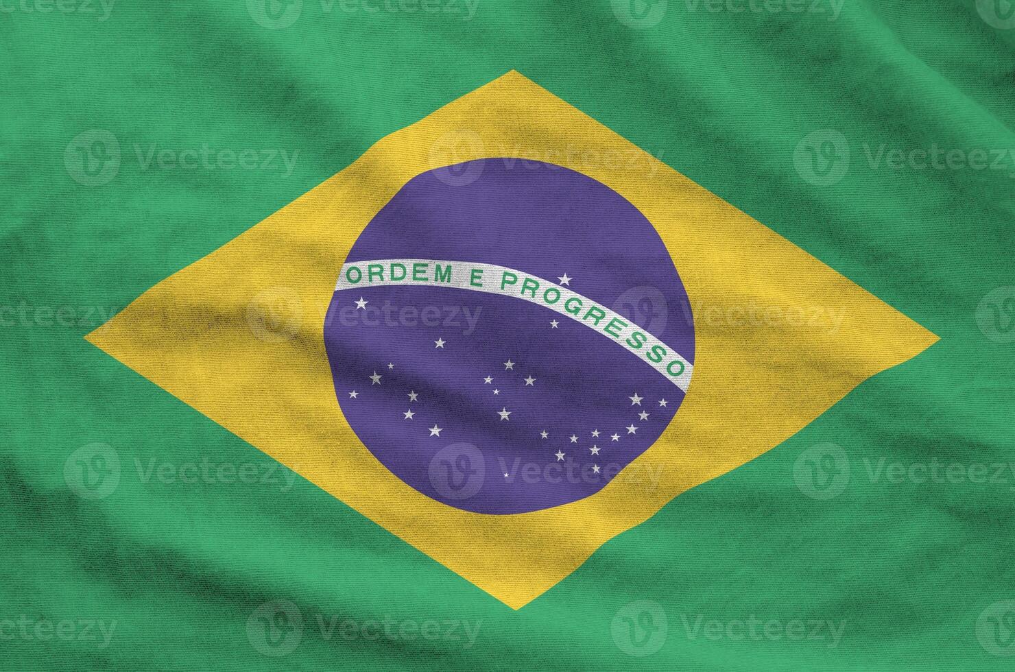 Brazil flag depicted on folded wavy fabric of old cloth photo