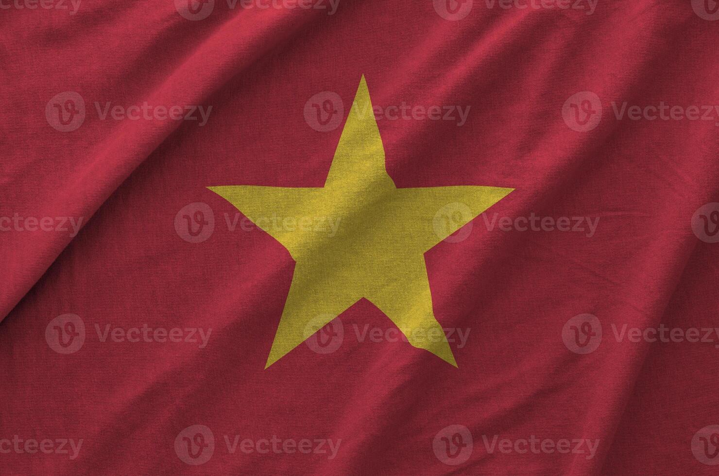 Vietnam flag depicted on folded wavy fabric of old cloth photo