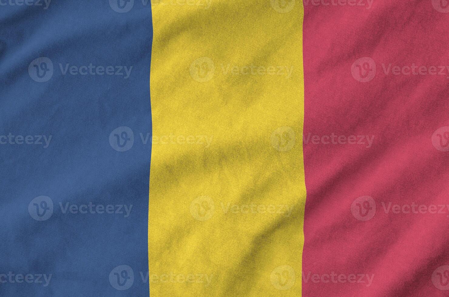 Chad flag depicted on folded wavy fabric of old cloth photo