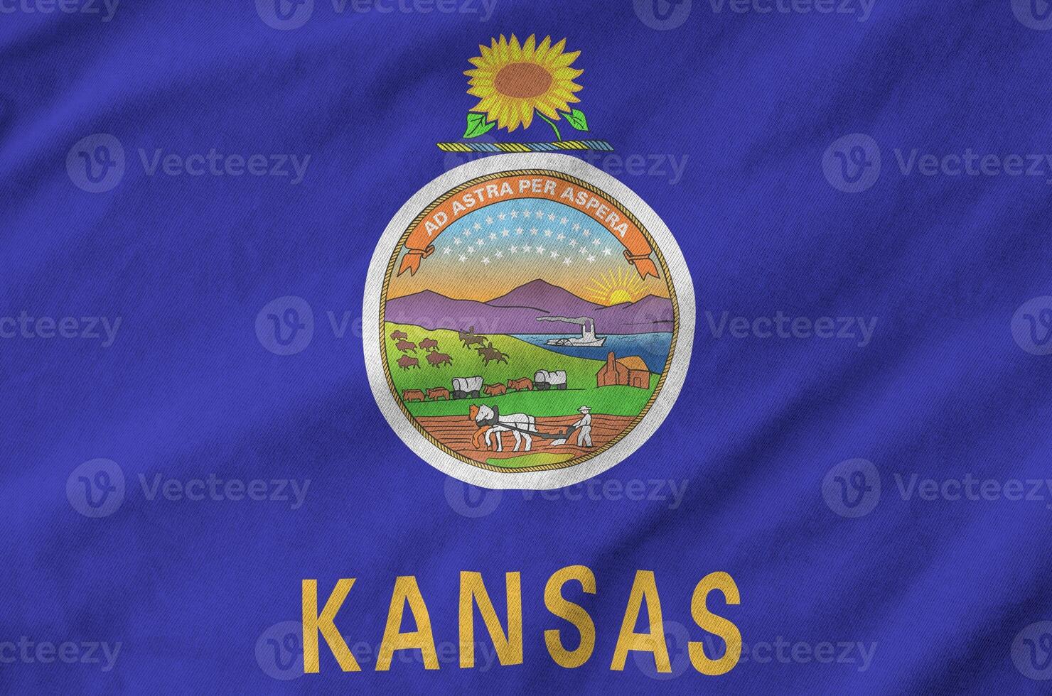 Kansas US state flag depicted on folded wavy fabric of old cloth photo