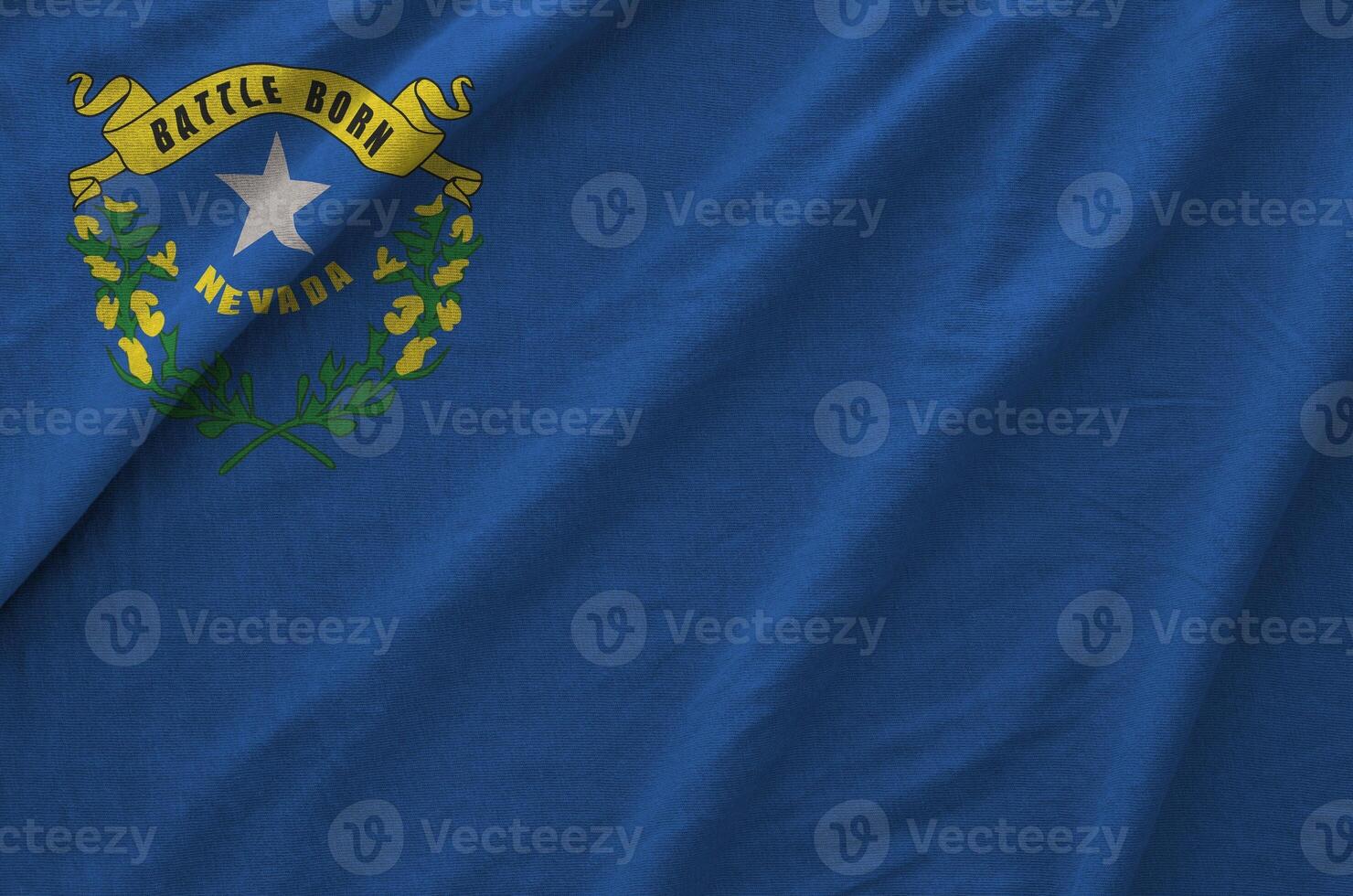 Nevada US state flag depicted on folded wavy fabric of old cloth photo