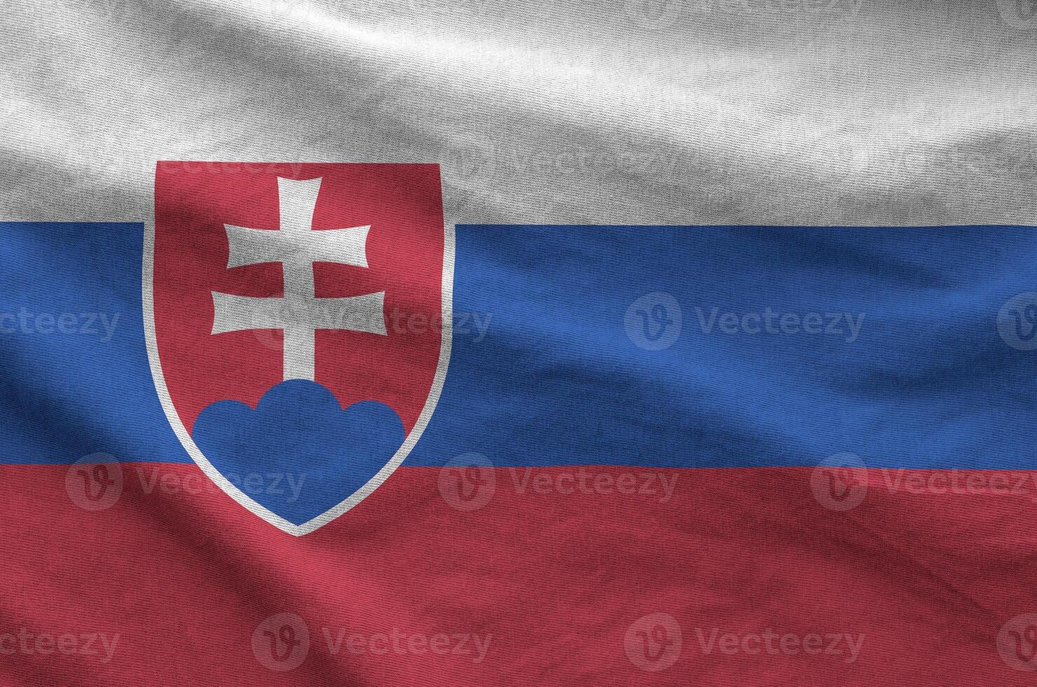 Slovakia flag depicted on folded wavy fabric of old cloth photo