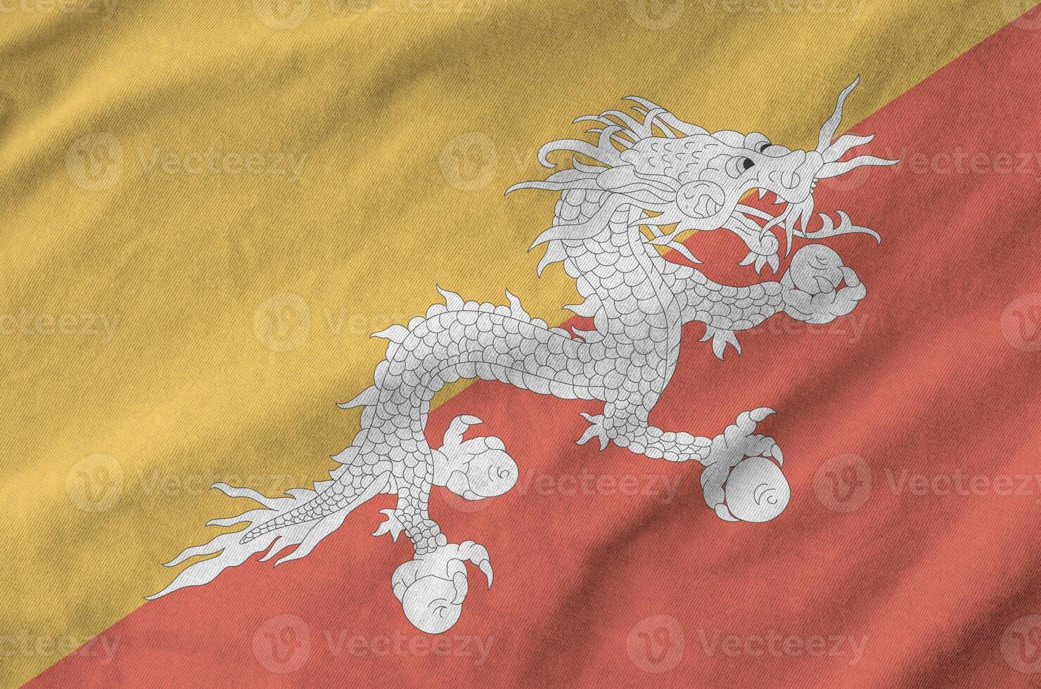 Bhutan flag depicted on folded wavy fabric of old cloth photo