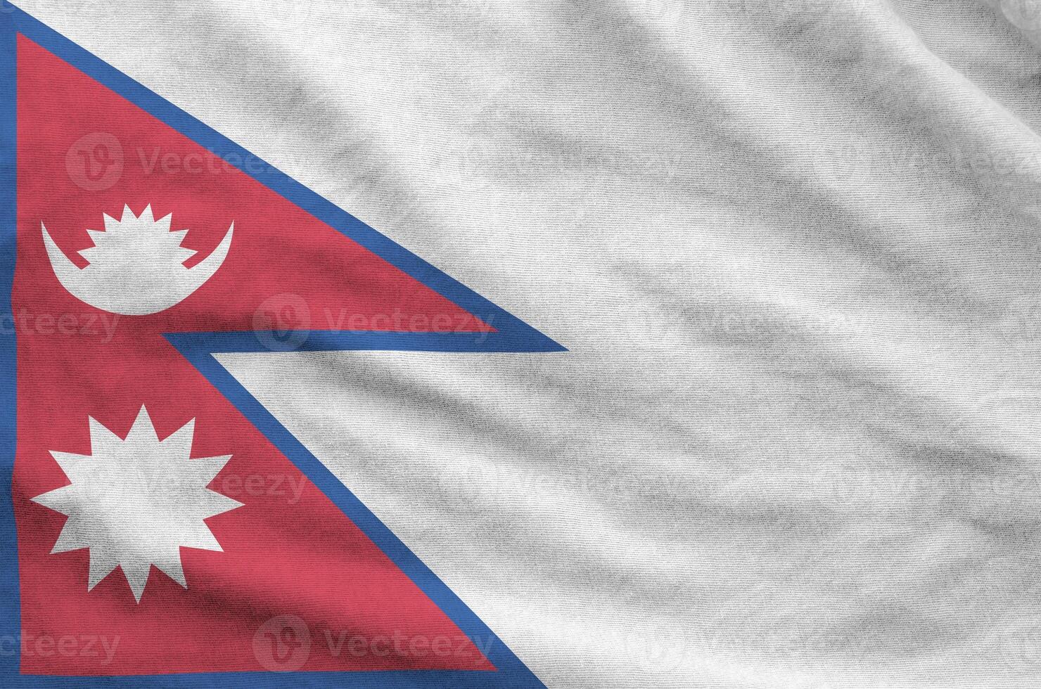 Nepal flag depicted on folded wavy fabric of old cloth photo