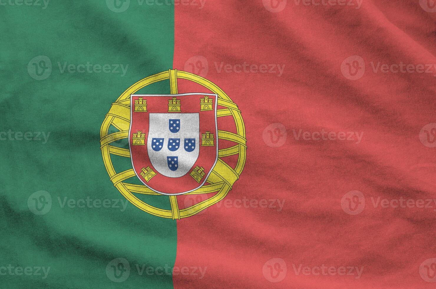 Portugal flag depicted on folded wavy fabric of old cloth photo