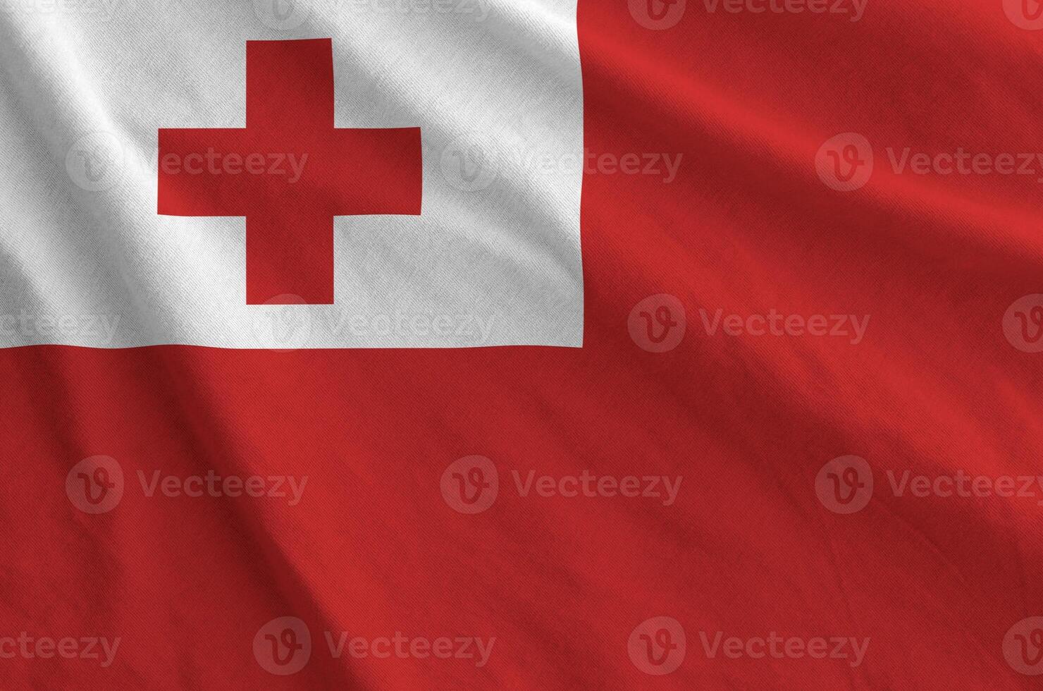Tonga flag depicted on folded wavy fabric of old cloth photo