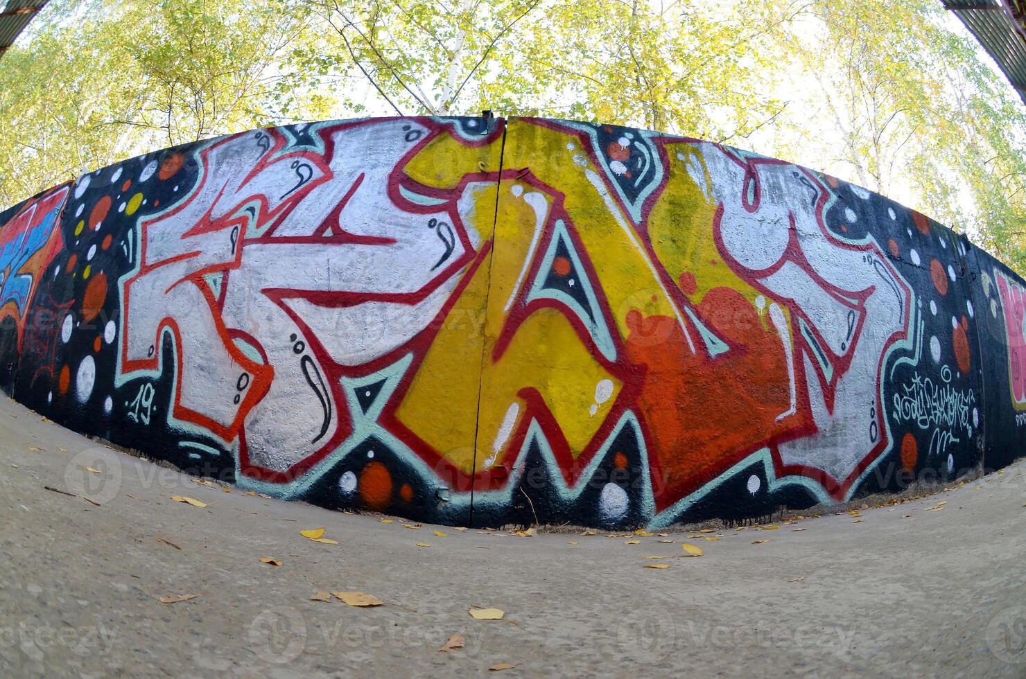 Fisheye shot of street art graffiti drawing on wall. Spray art artwork with different colors and outlines photo
