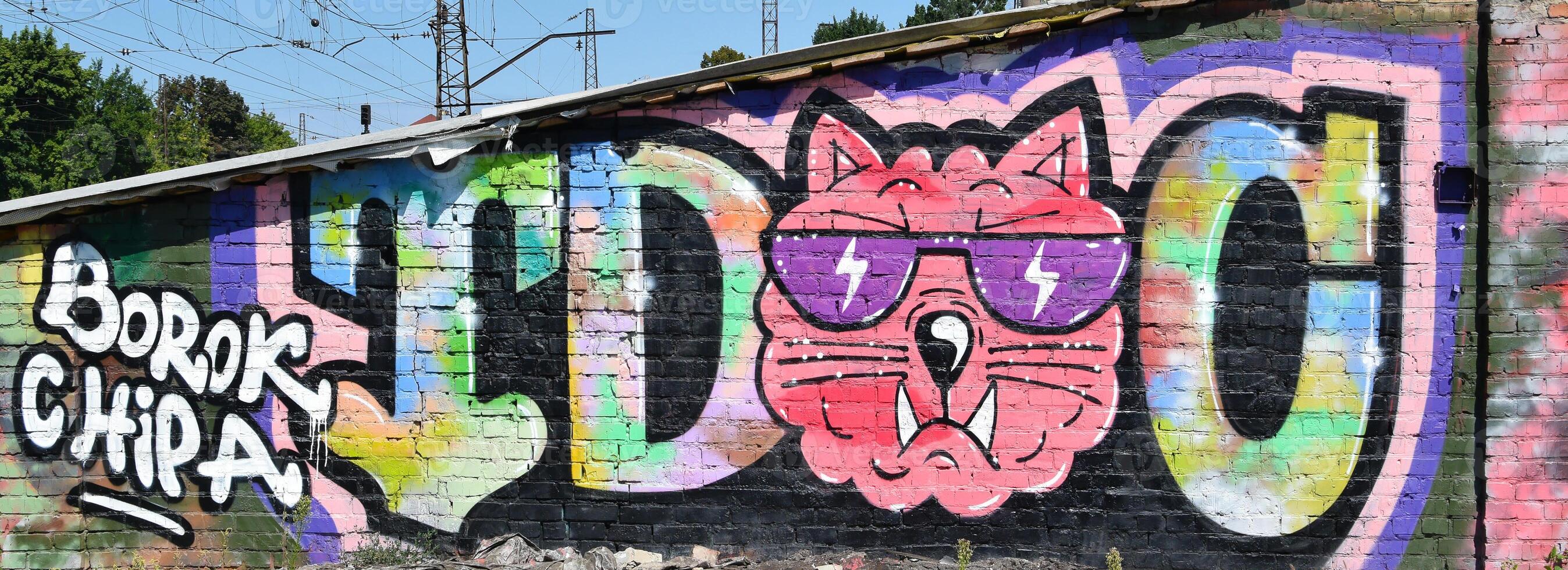 Colorful background of graffiti painting artwork with bright aerosol outlines on wall. Old school street art piece made with aerosol spray paint cans. Contemporary youth culture photo