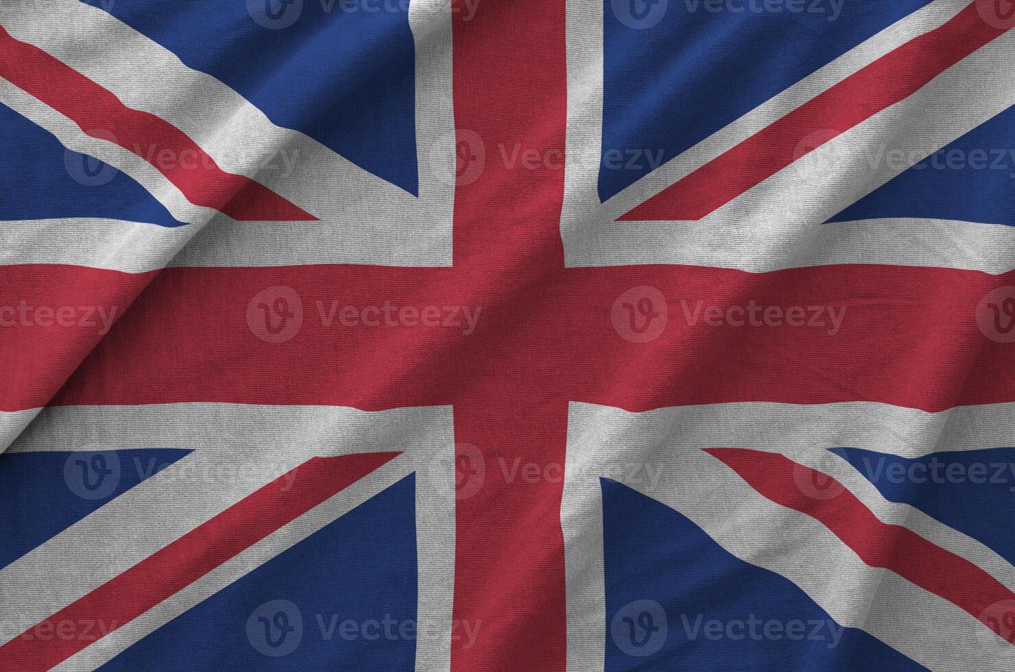 Great britain flag depicted on folded wavy fabric of old cloth photo